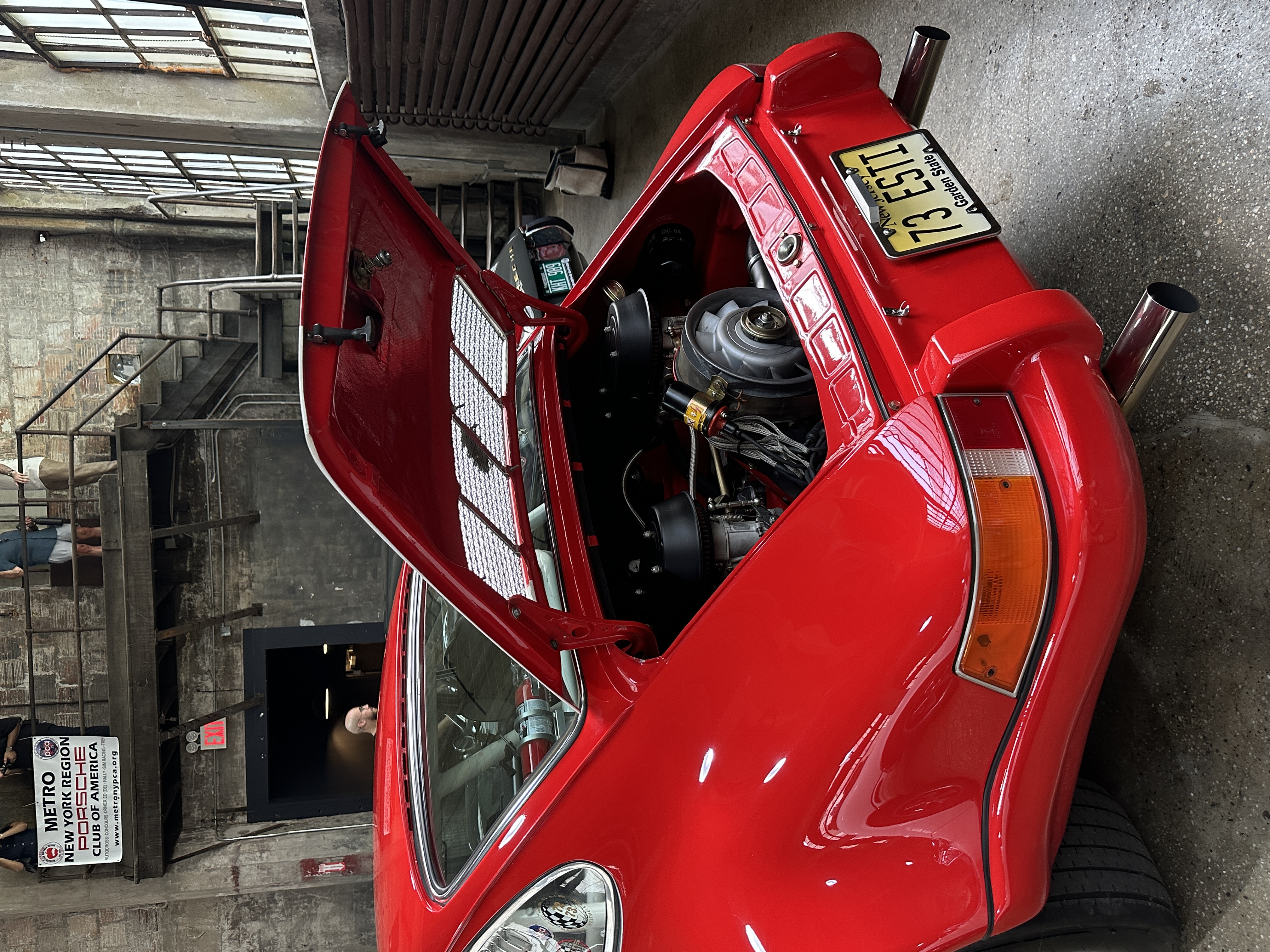 the rear engine of a vintage porsche in red