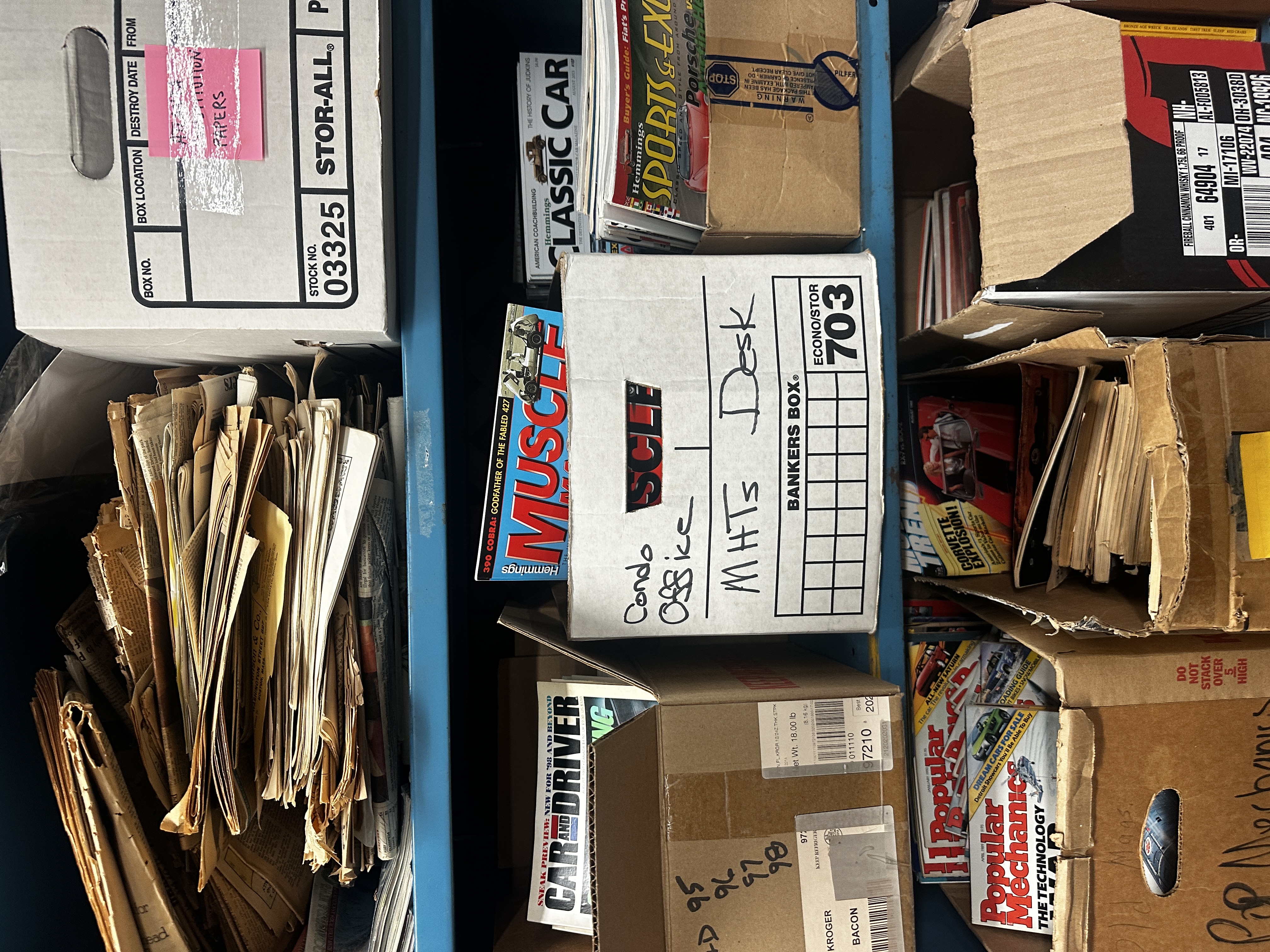a shelf full of vintage car magazines