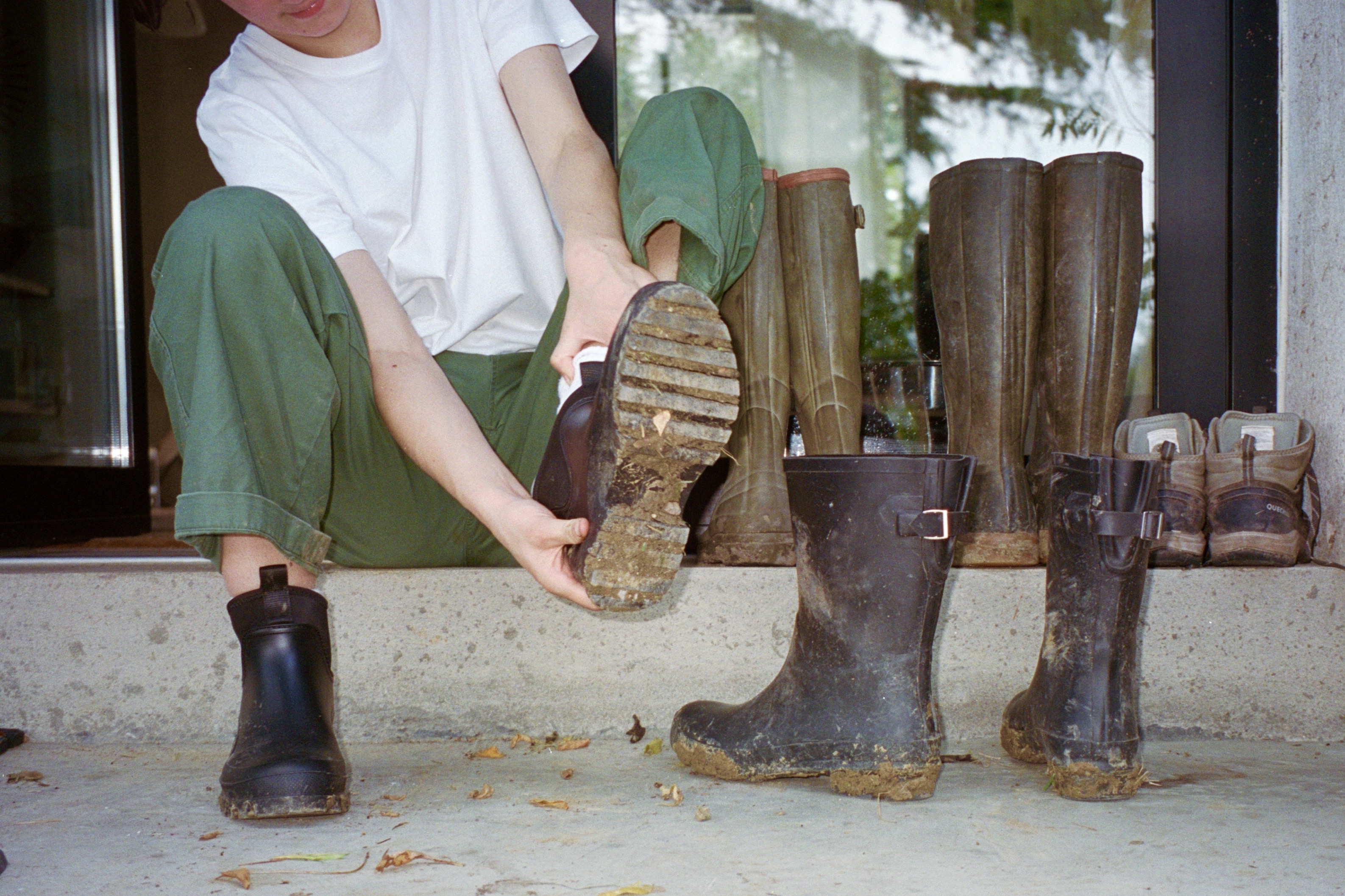 girl removing muddy boots