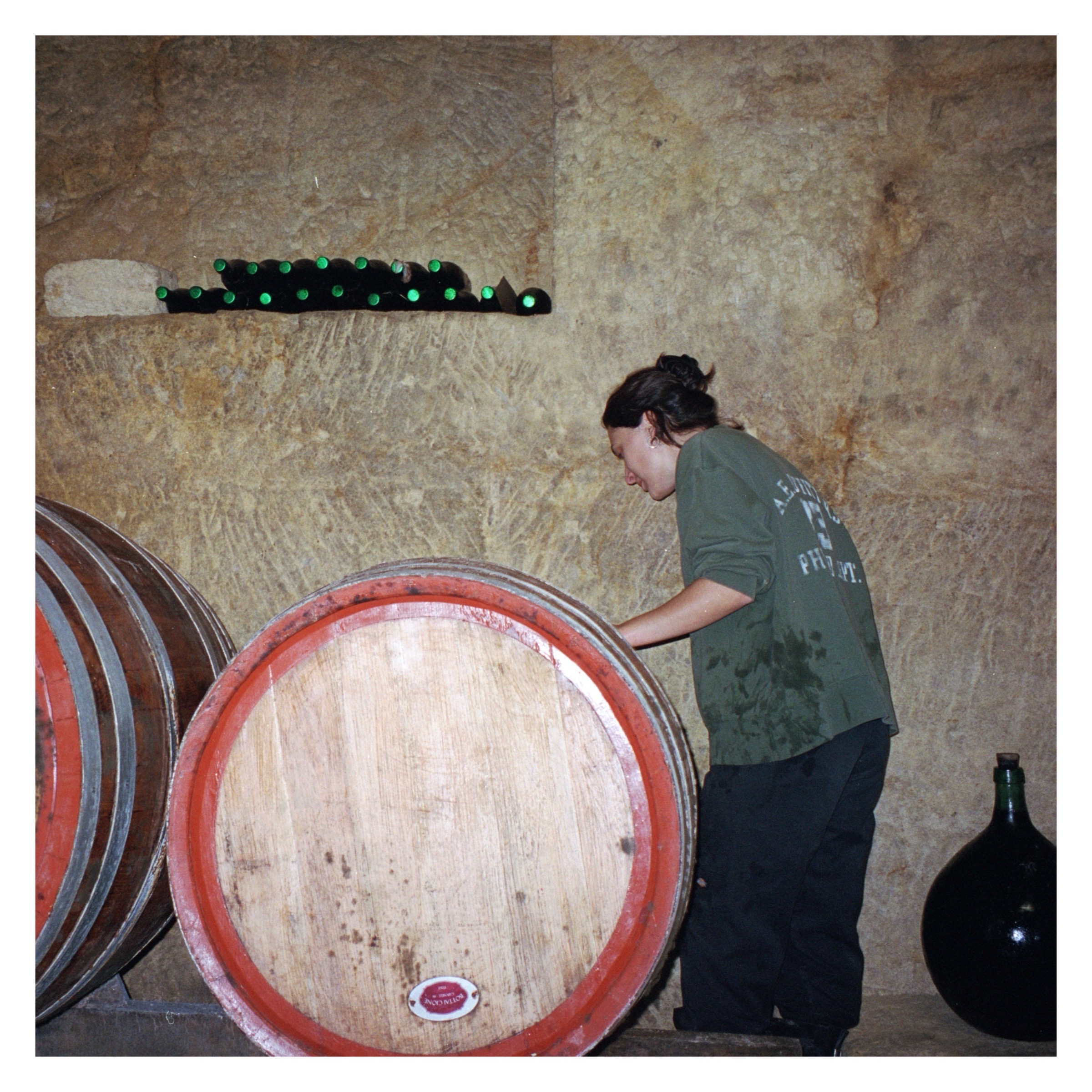 girl standing by oak barrels